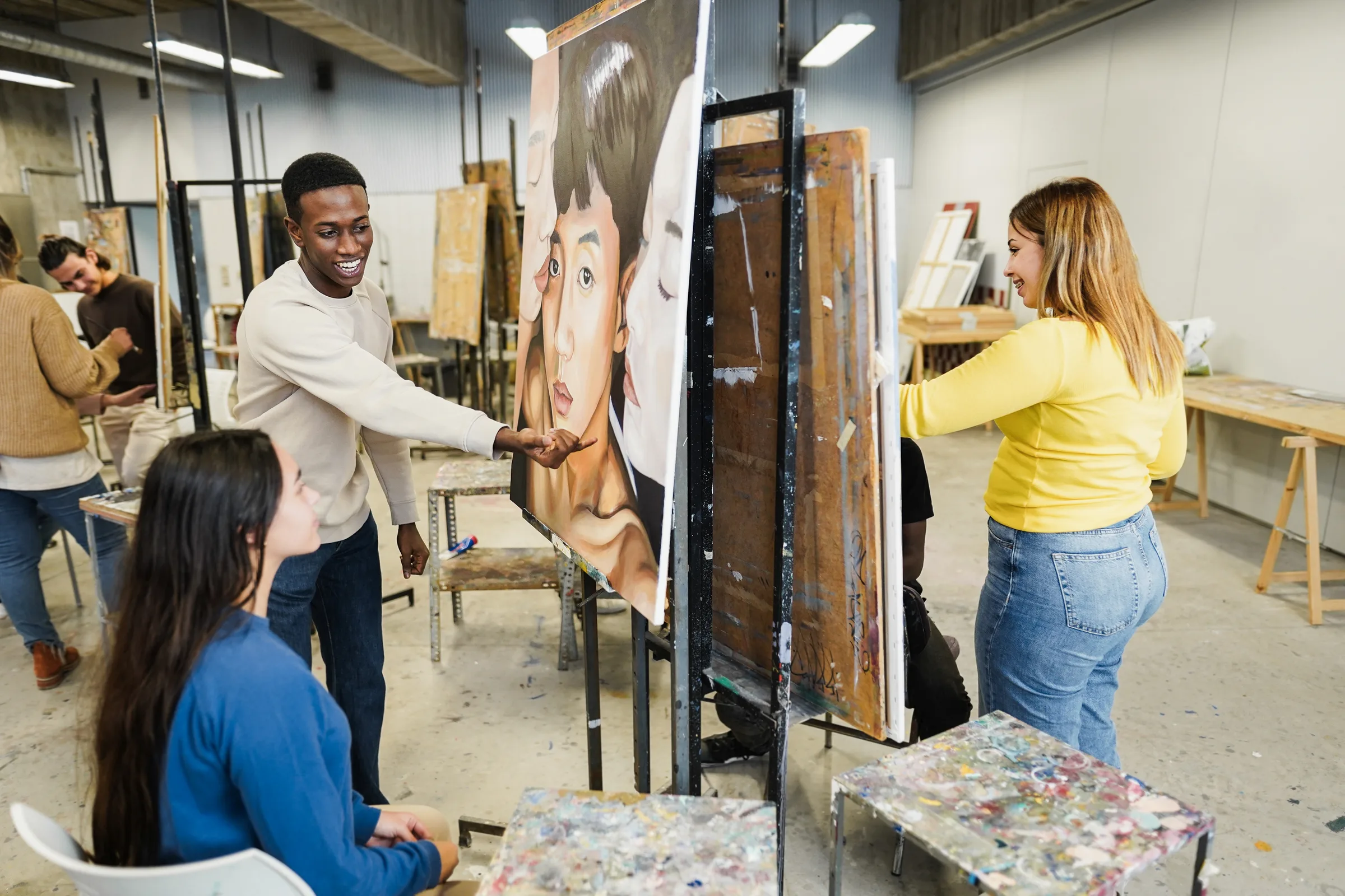 Art students painting together in a bright studio