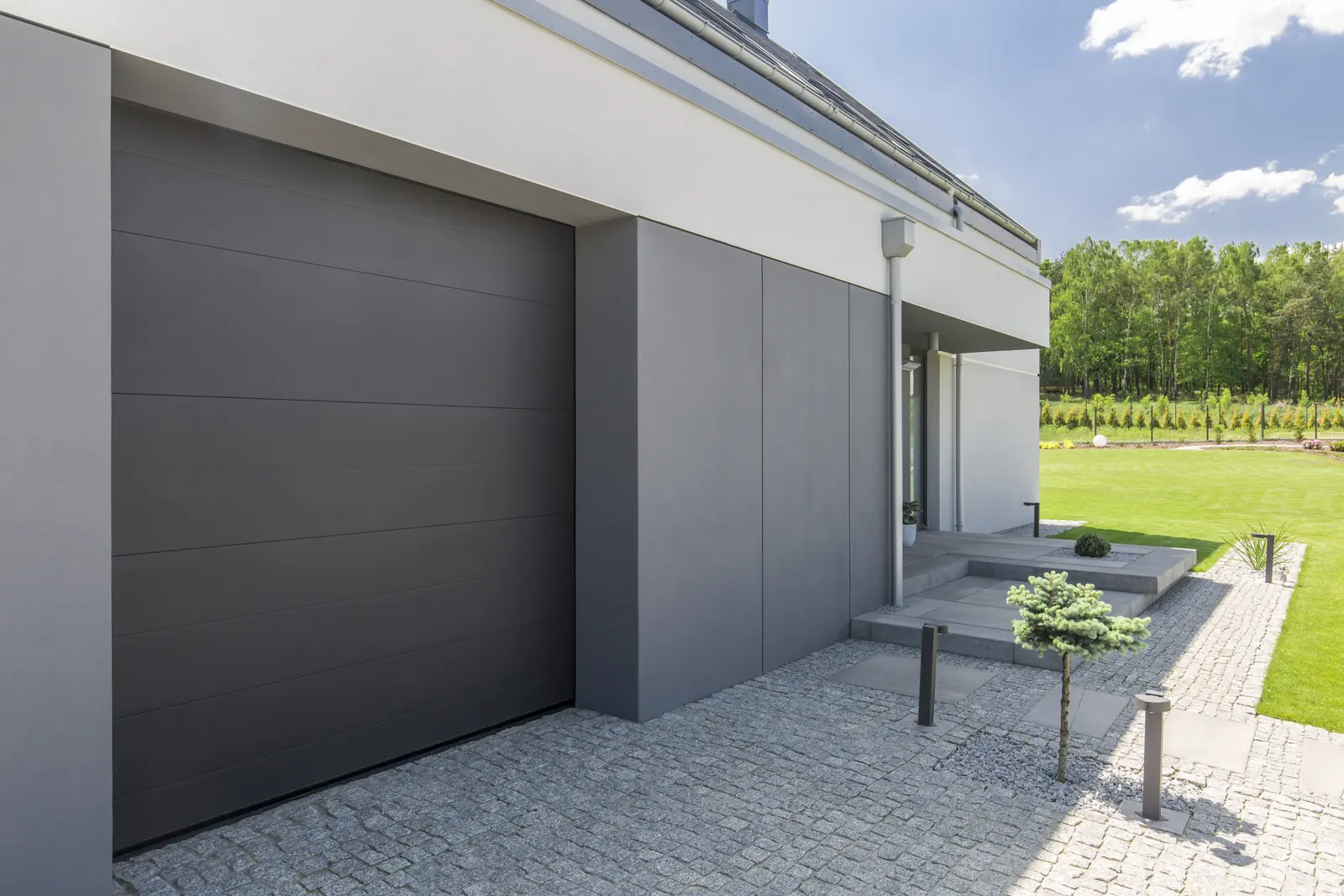 A modern home with a dark garage and clean-lined facade