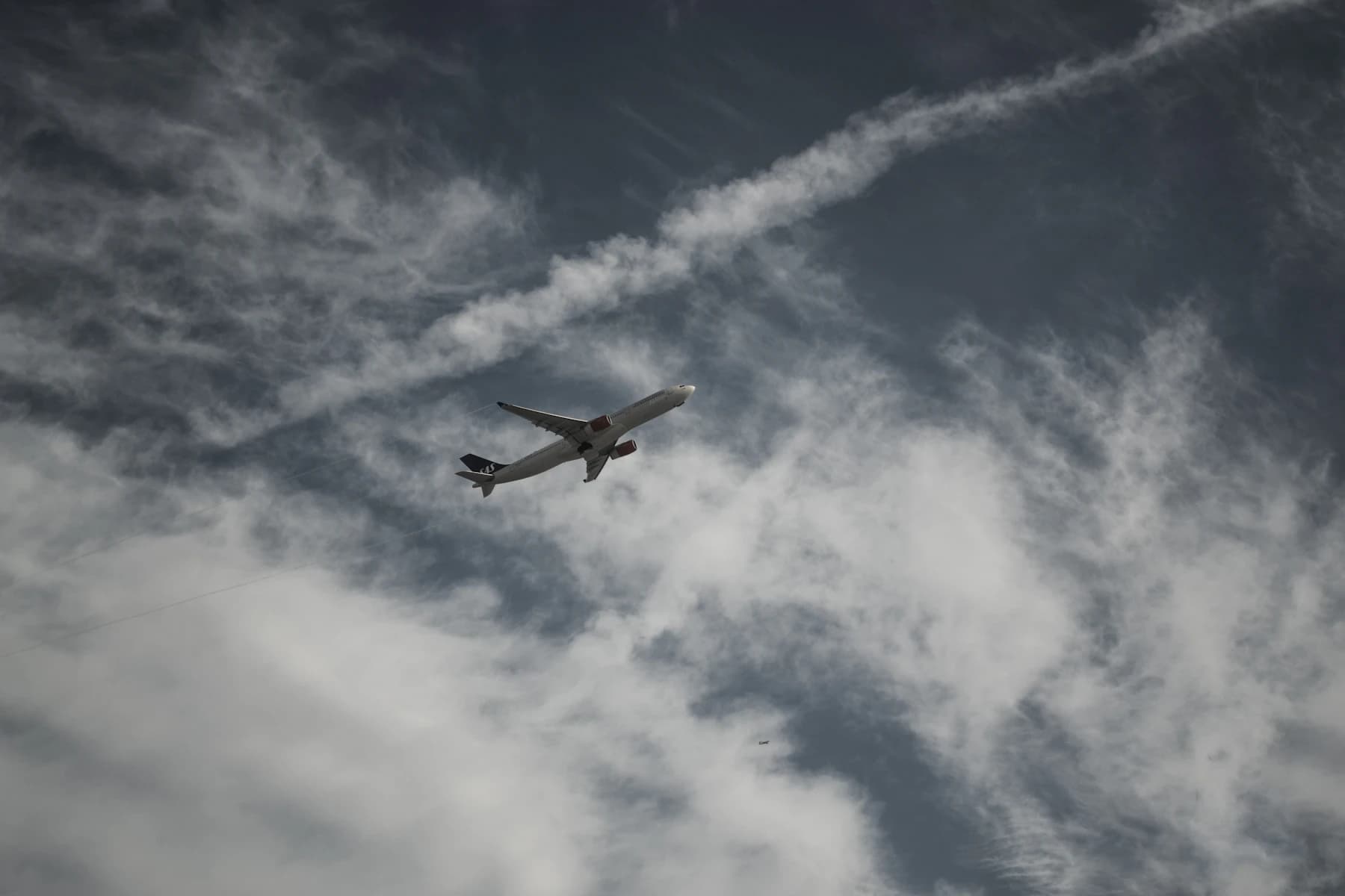 A passenger jet crossing the sky above the nearby Playa del Rey shoreline