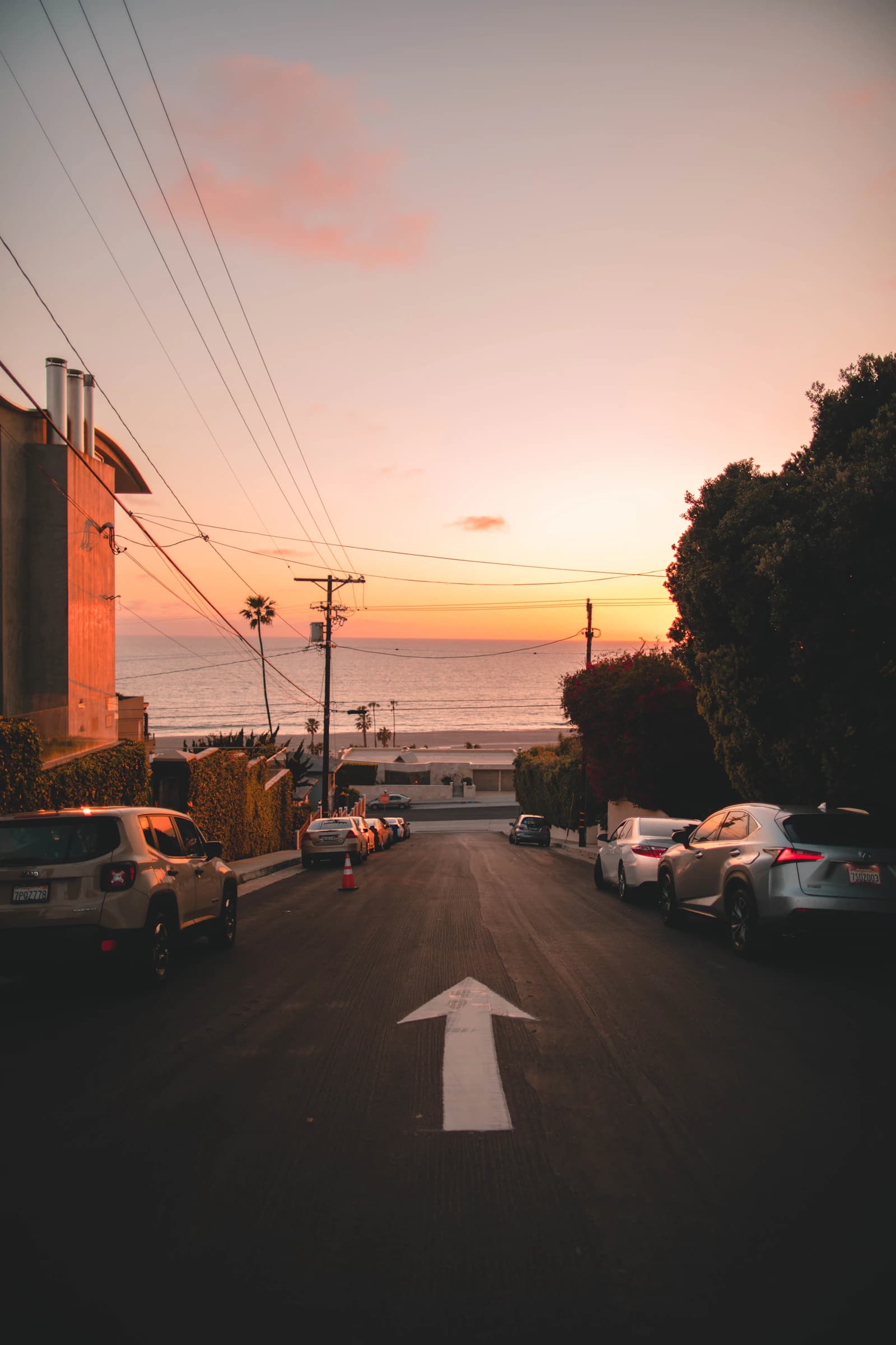 A quiet residential street near Westchester descending toward a warm coastal sunset