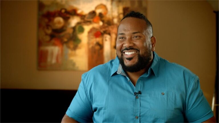 A man smiling during an interview